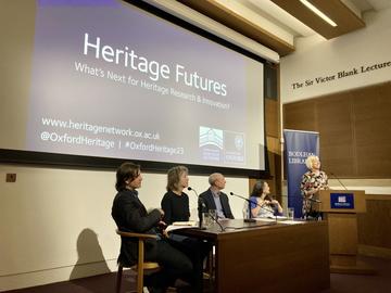 A panel sitting in front of a Heritage Futures presentation