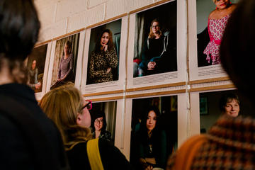 Close up of a member of the public looking at the 100 Women of Oxford exhibition