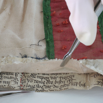 Forcepts used to peel back material from manuscript